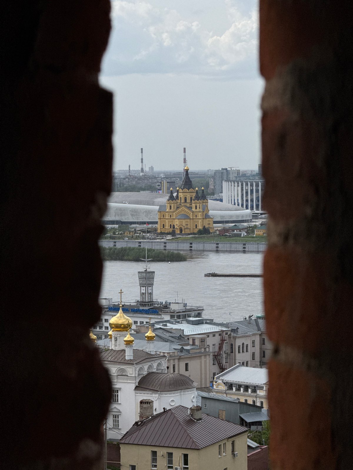 Cityscape viewed through historic fortification opening in Nizhny Novgorod