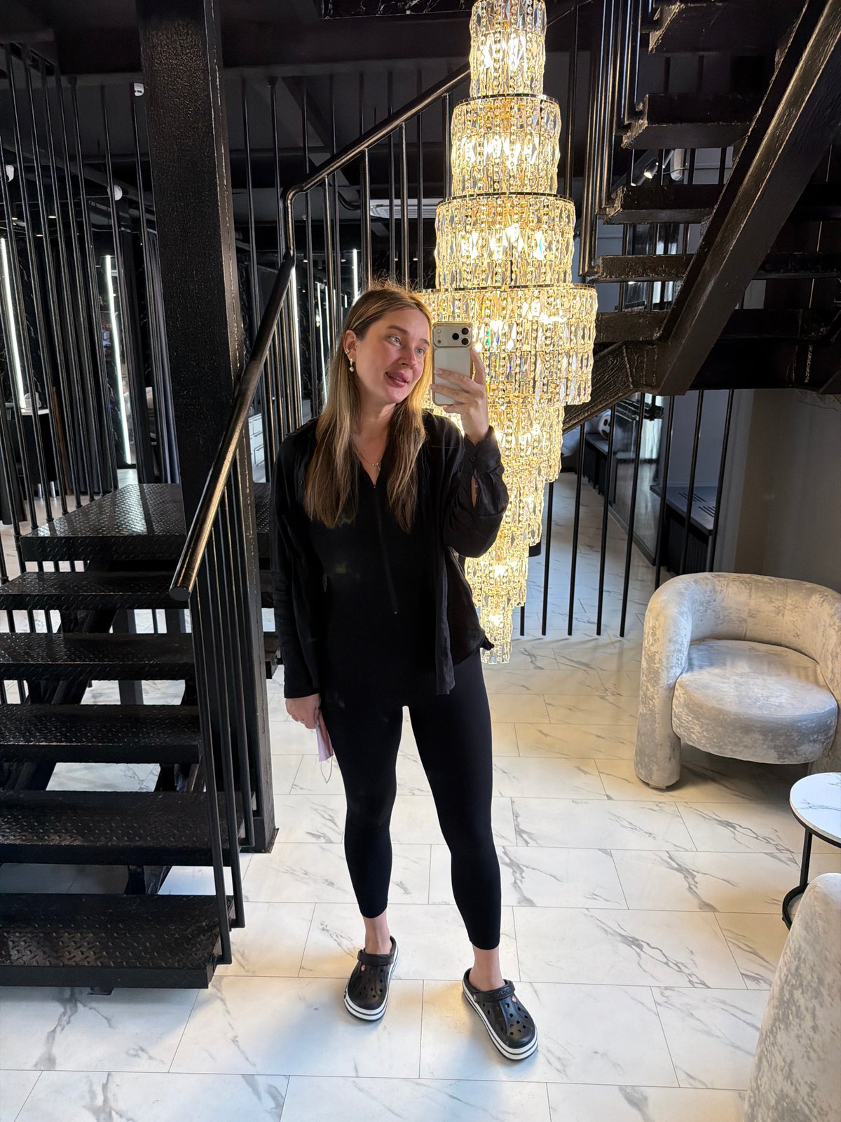 Woman takes morning selfie on ornate staircase in Moscow home