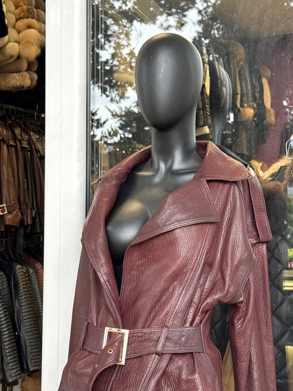 Store window display features burgundy leather garment in Montenegro