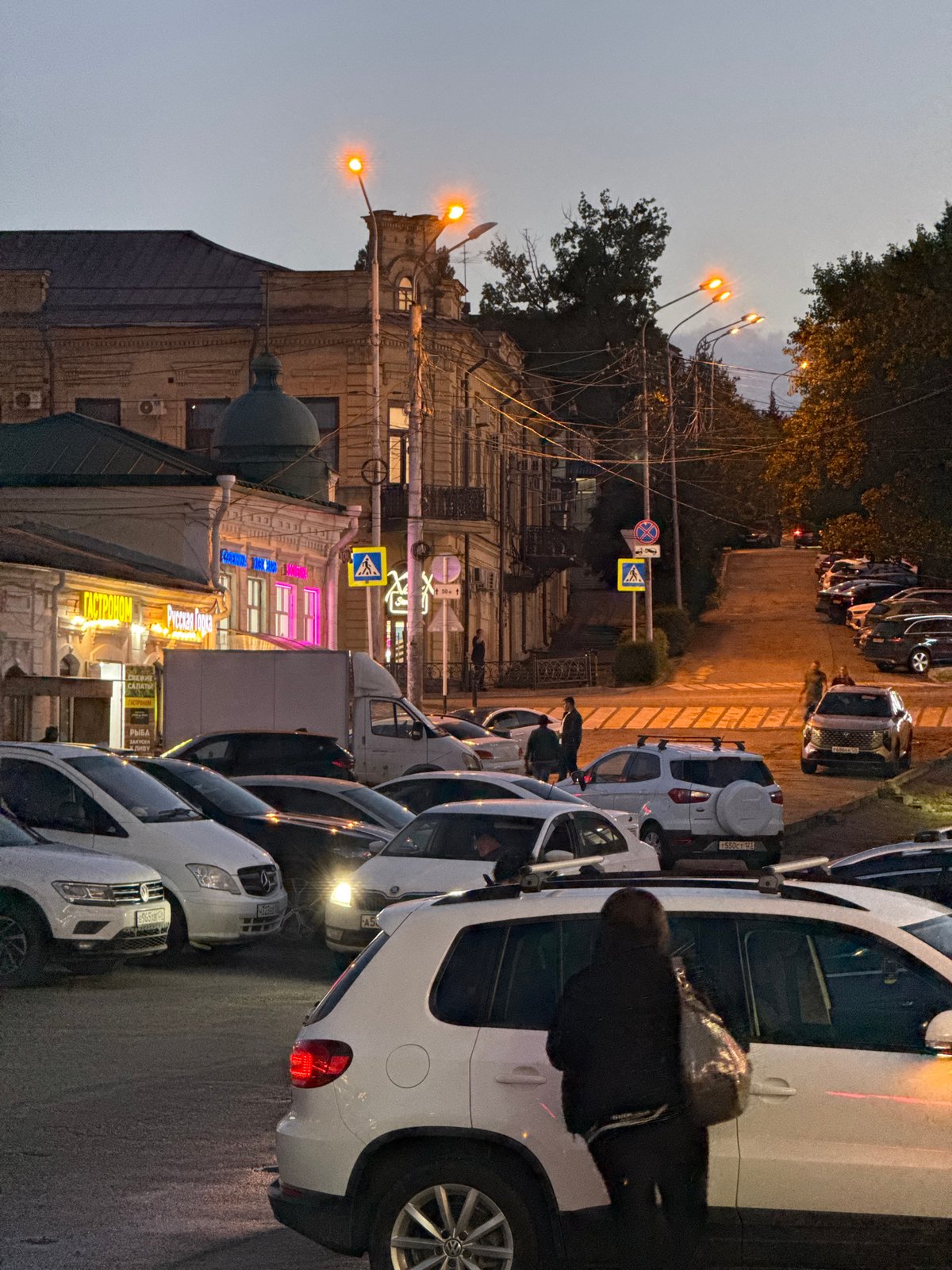 Stavropol commercial district at dusk, storefronts and street life