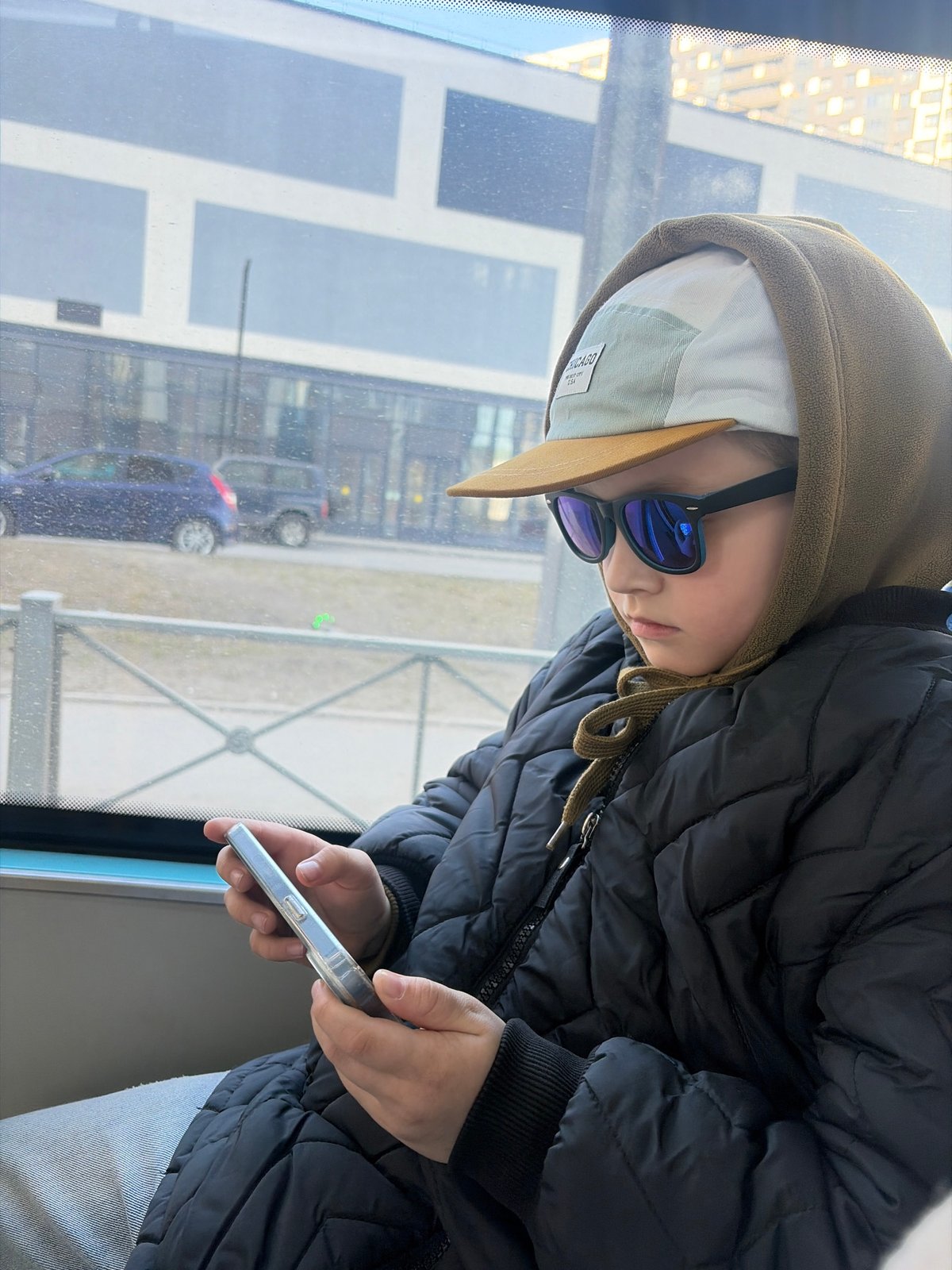Child with smartphone spotted on Saint Petersburg public transit