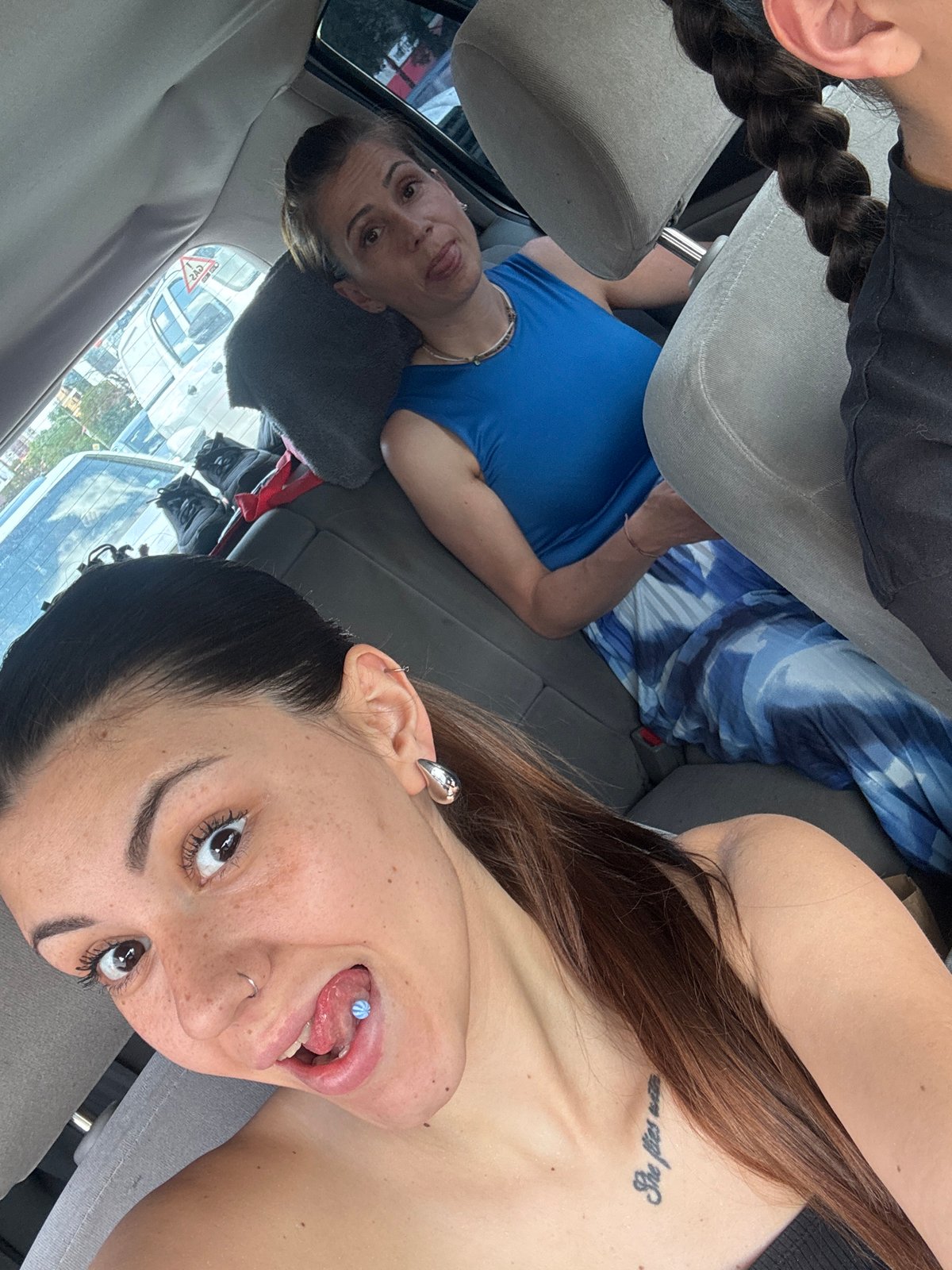 Young woman takes selfie in car with friends in Sofia