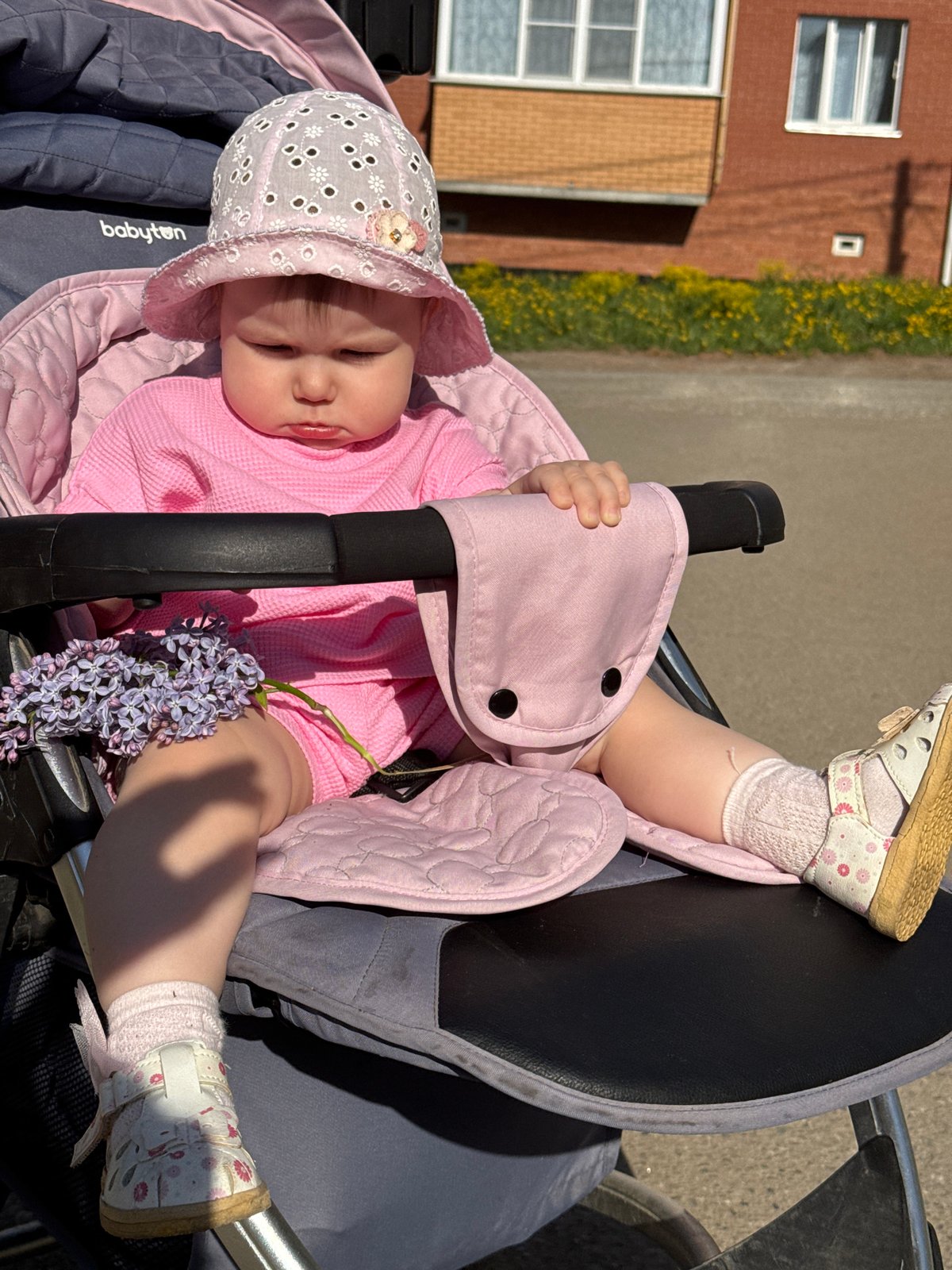 Baby enjoys spring outing in stroller in Zav'yalovo