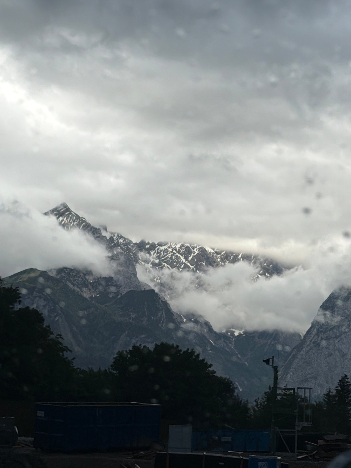 Snow-capped mountains observed through clouds near Garmisch-Partenkirchen