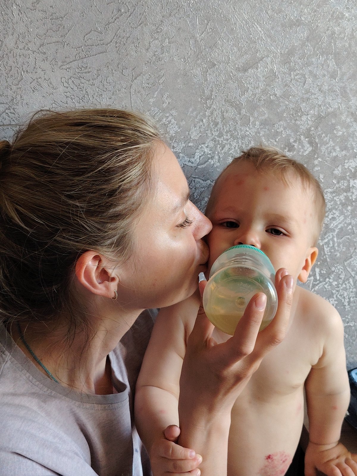 Family moments documented during baby's feeding time in Chaikovsky