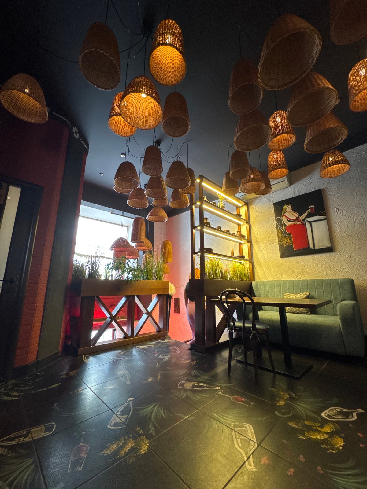 Rustic restaurant interior in Chernivtsi, lit by woven basket lamps