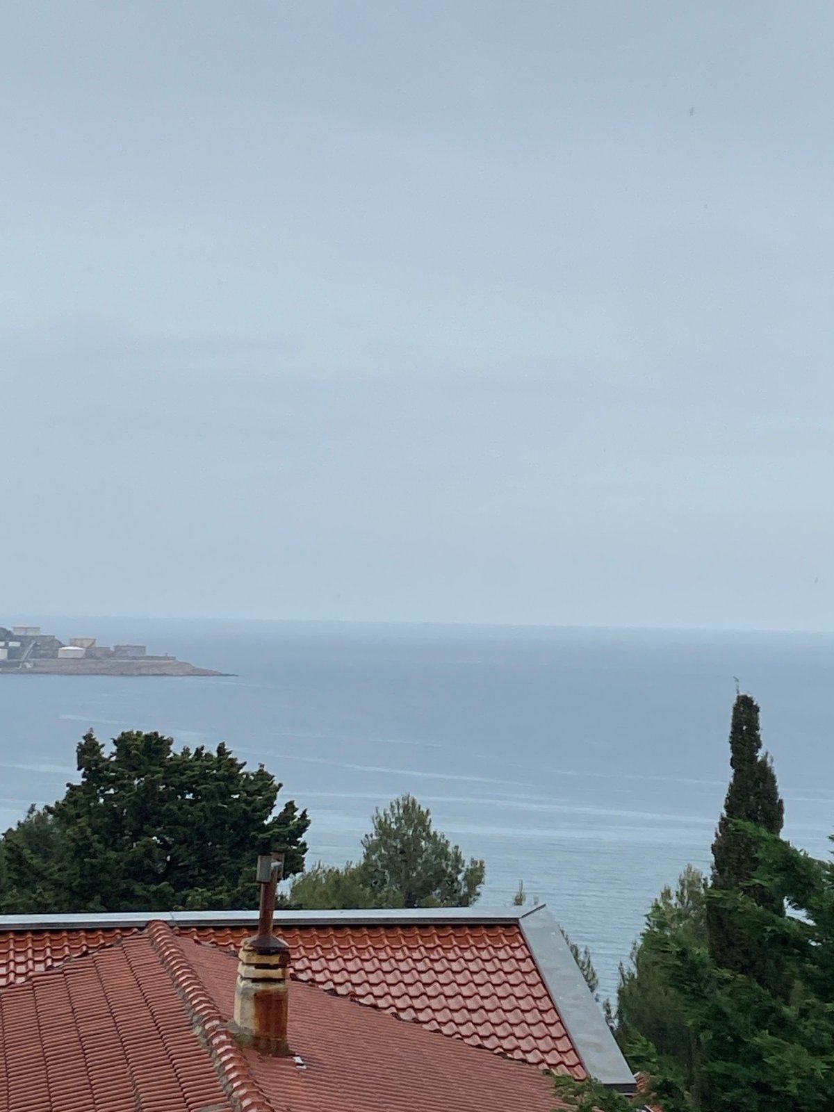 Tourist documents rainy day in Šušanj, Montenegro coastal town