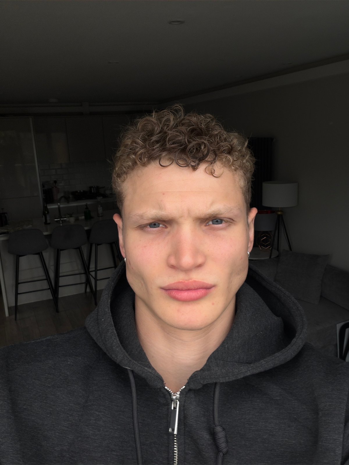 Young man photographed with serious expression in London