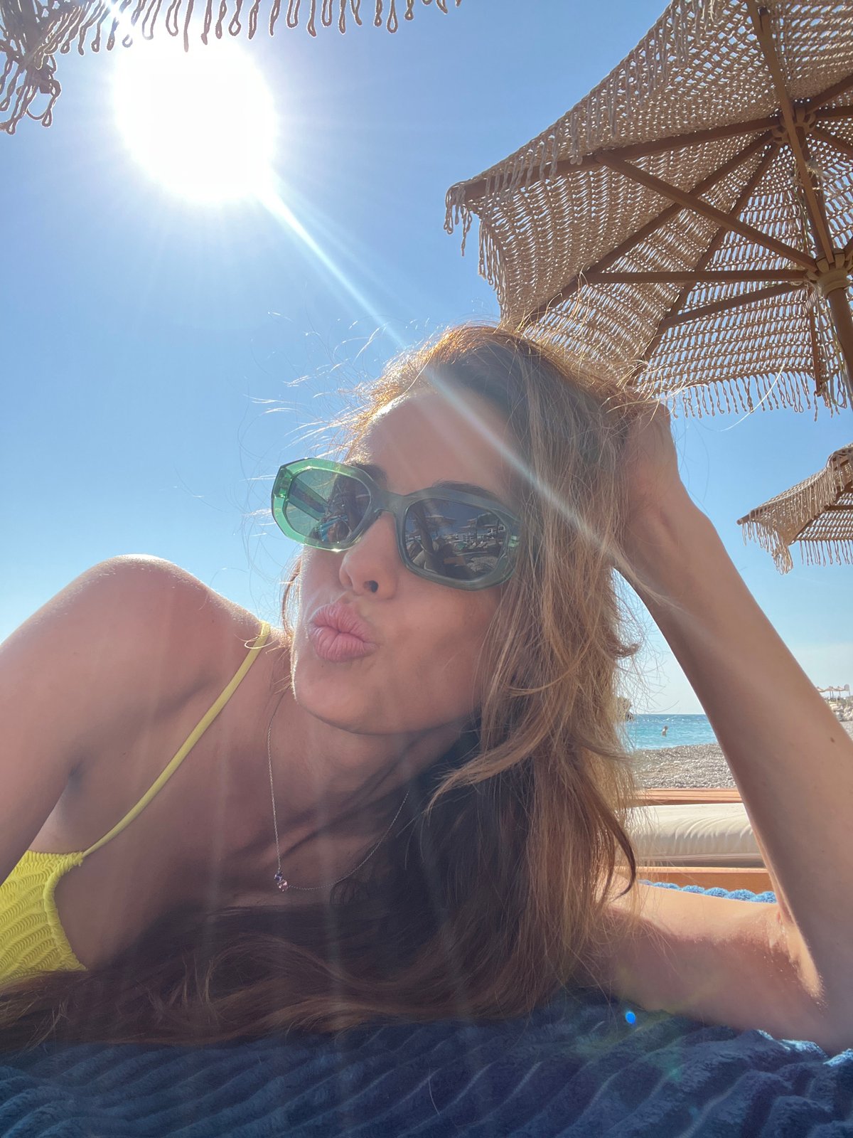 Woman sunbathes at Pečurice beach, Montenegro