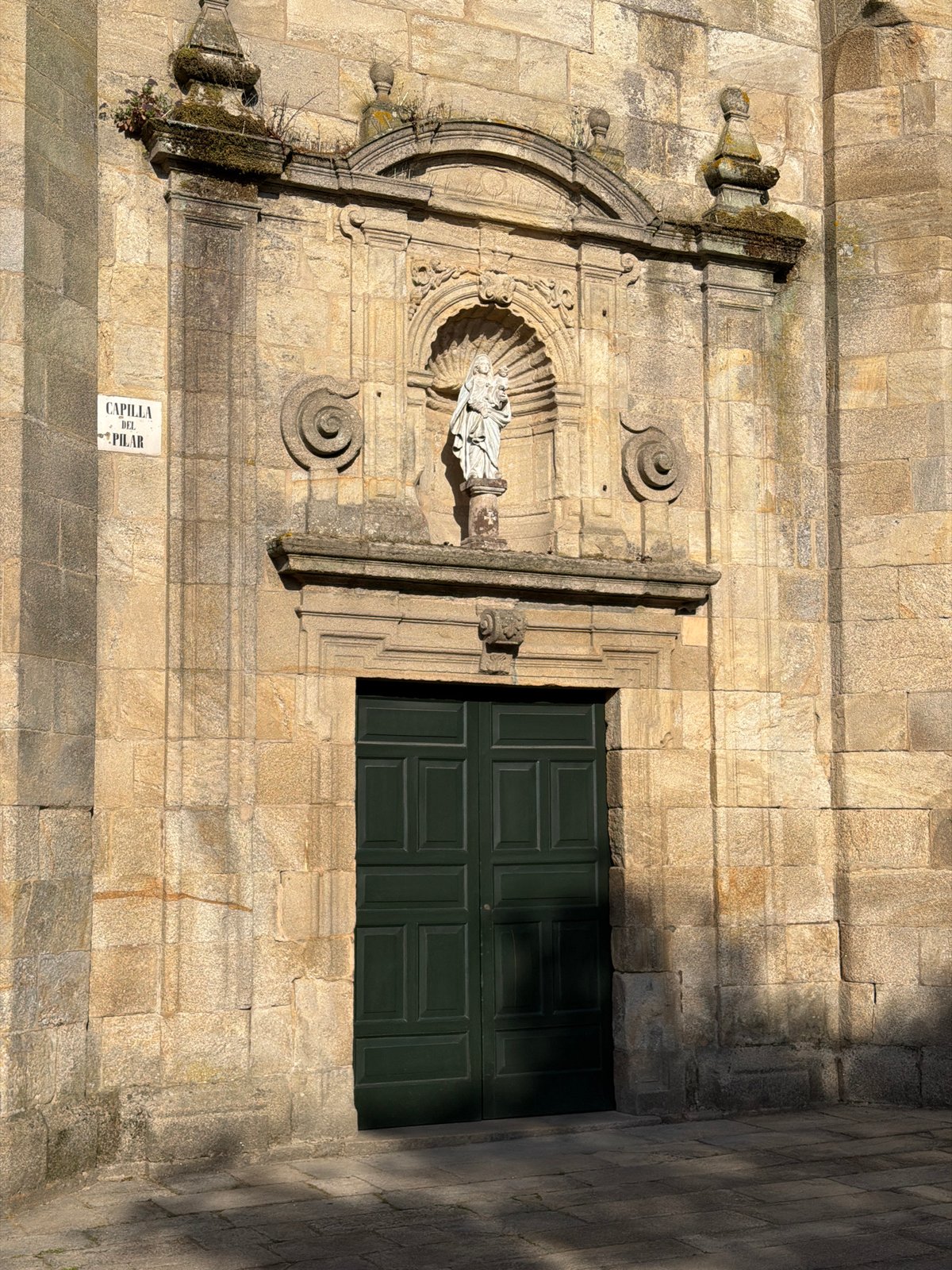 Walking the old stones outside a Santiago church