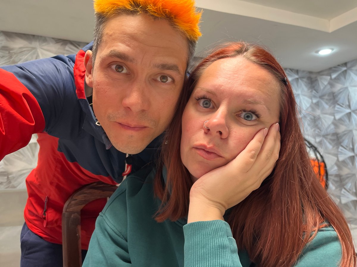 Couple takes playful selfies indoors in Chaikovsky, Russia