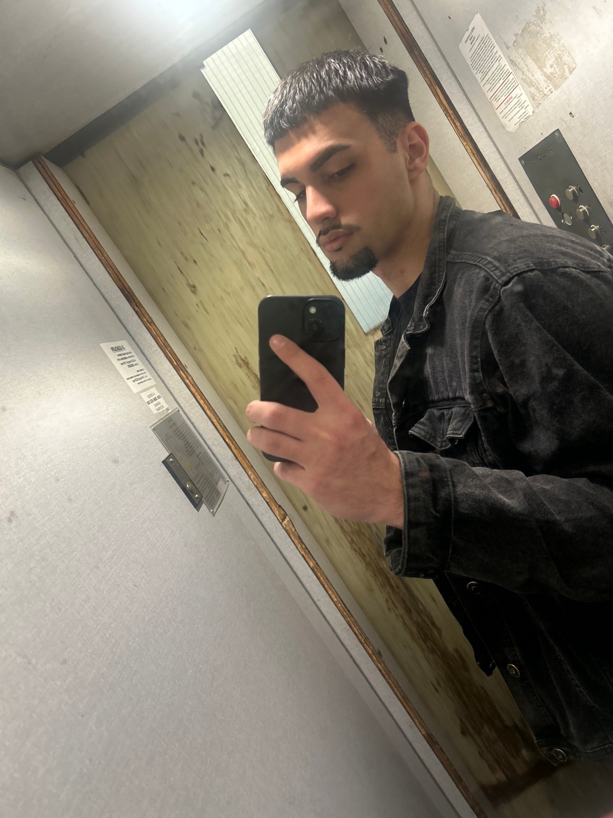 Man takes selfie in wood-paneled elevator in Sofia