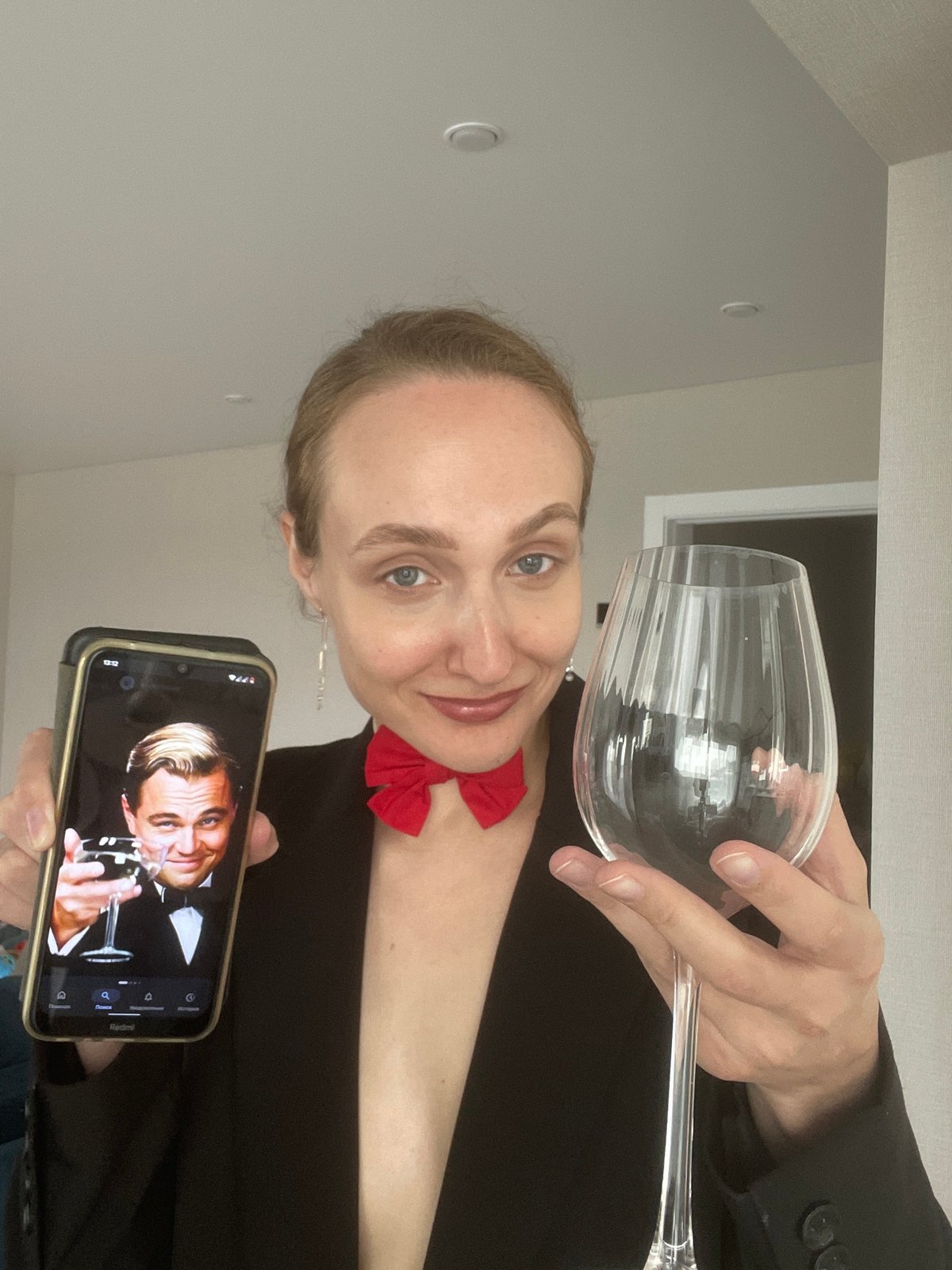 Woman mimics Leonardo DiCaprio with drawn mustache, wine glass pose