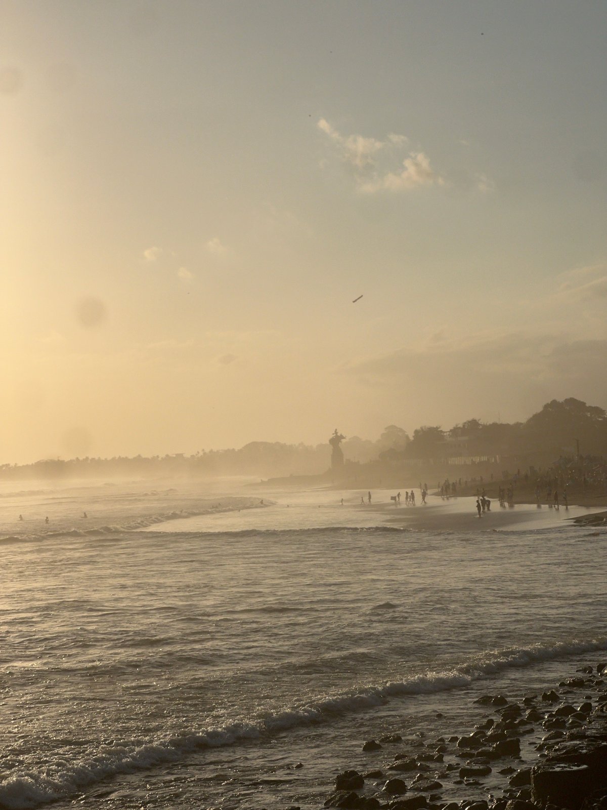 Golden hour at North Kuta Beach — crowds, food stalls, sunset