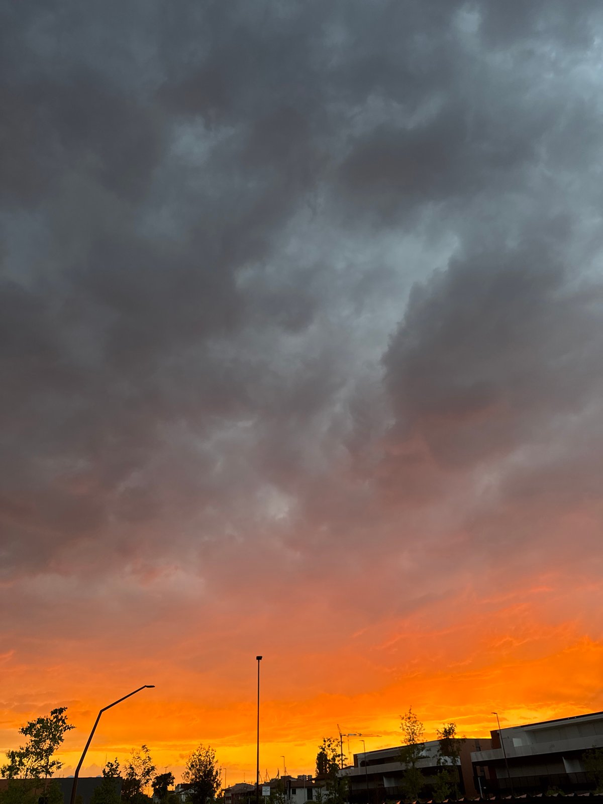 Fiery sunset градients light up the sky over Mejaniga