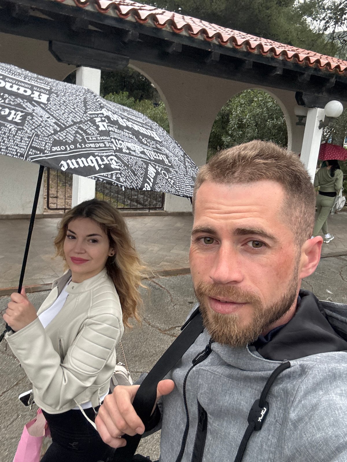 Couple documents rainy morning routine in coastal Budva
