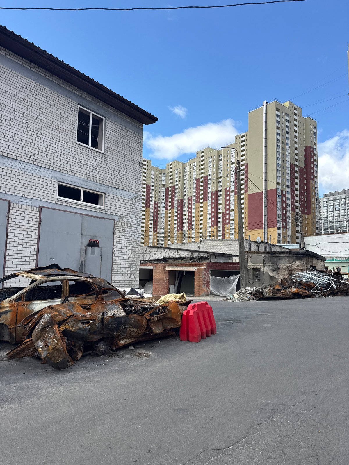 Burnt vehicles and damaged garages near Kyiv residential building