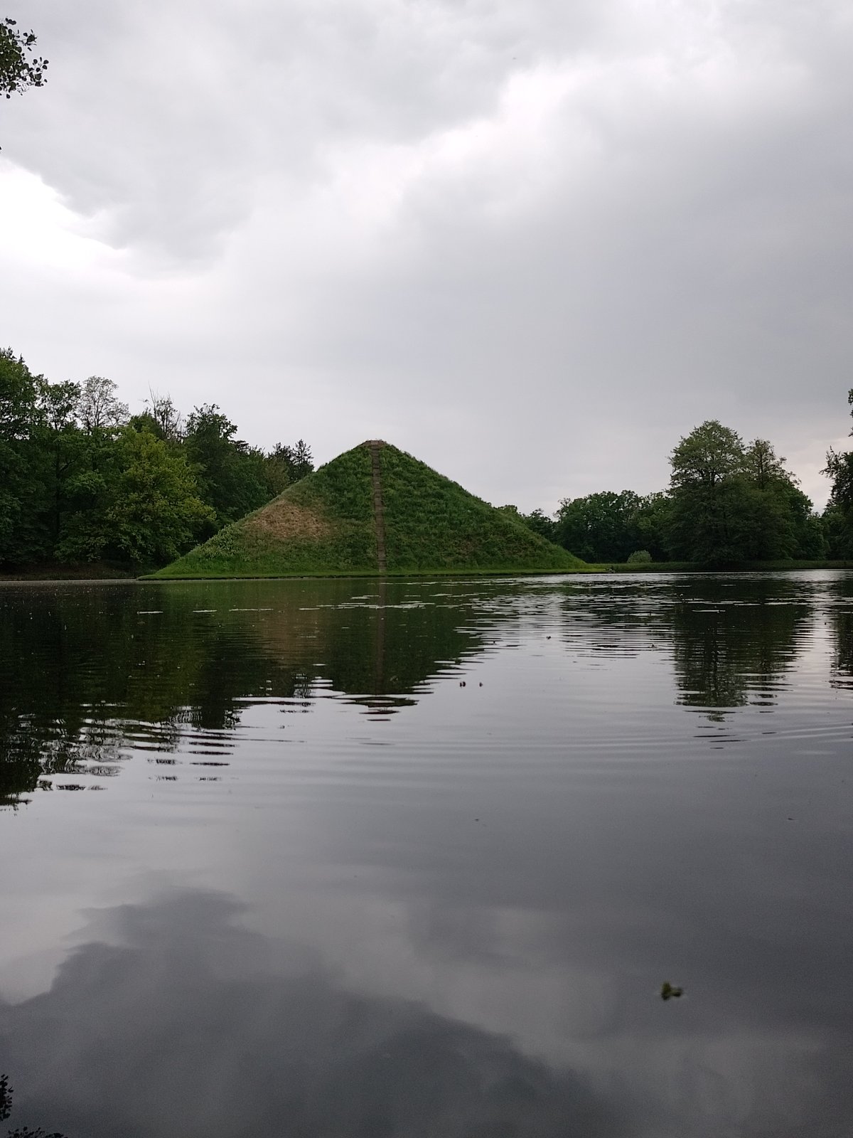 Visitors photograph tiered pyramid hill at Magdeburg's Rotehornpark