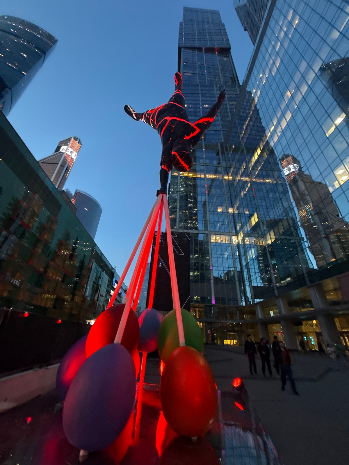 Glowing neon-cracked figure sculpture lights up a Moscow evening