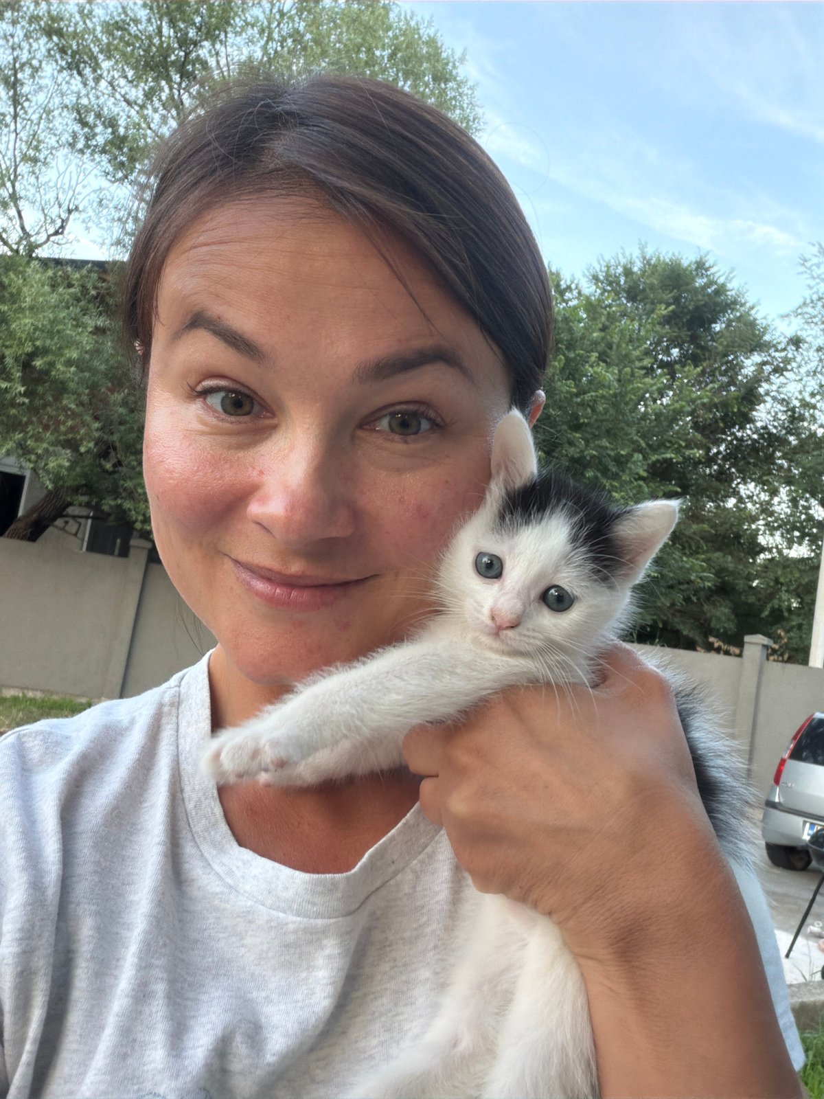 Woman with kitten amid construction scenes in Montenegro