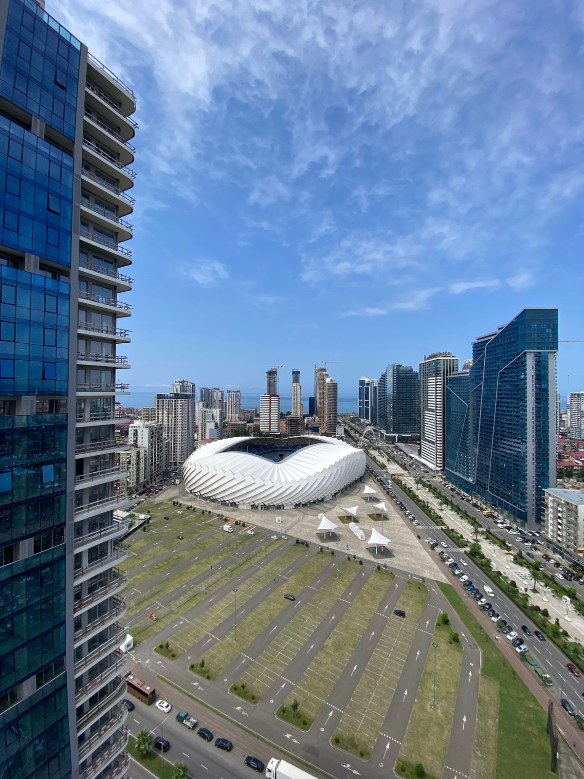 Batumi's coastal skyline mid-construction, stadium and glass towers rising