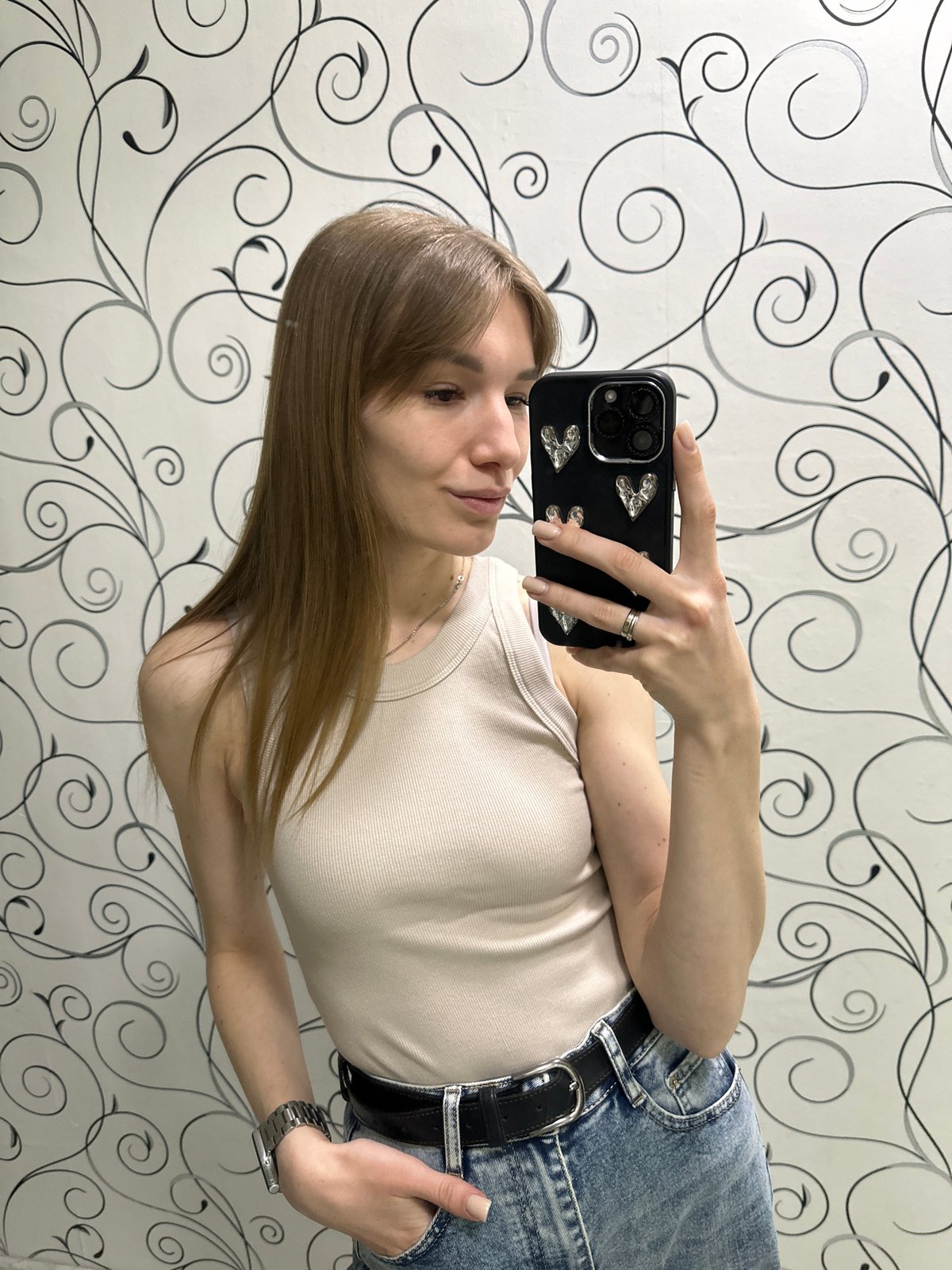 Woman takes selfie with decorated phone in Chaikovsky, Russia