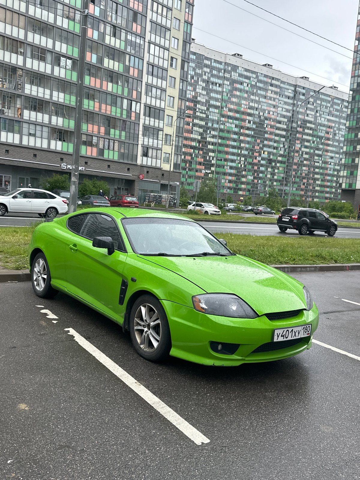 Vehicles parked on wet streets in Murino, Russia