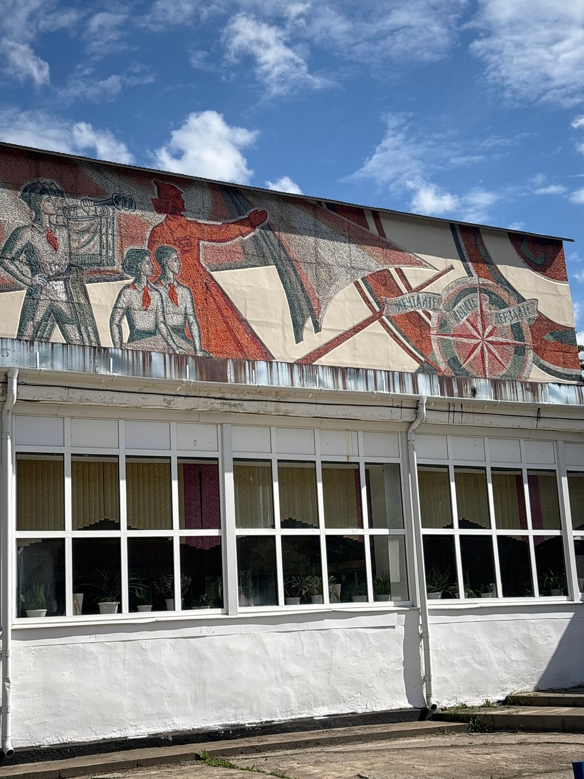 Child plays near historic mural in Bolkovo, Russia