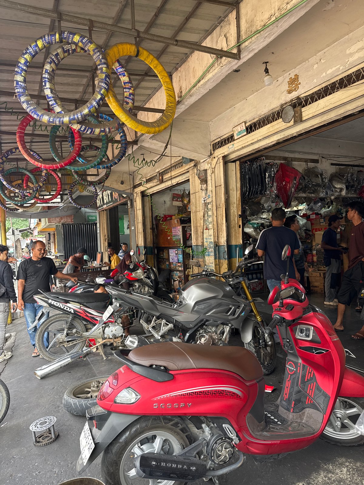 Inside a busy motorcycle repair shop in Banda Aceh