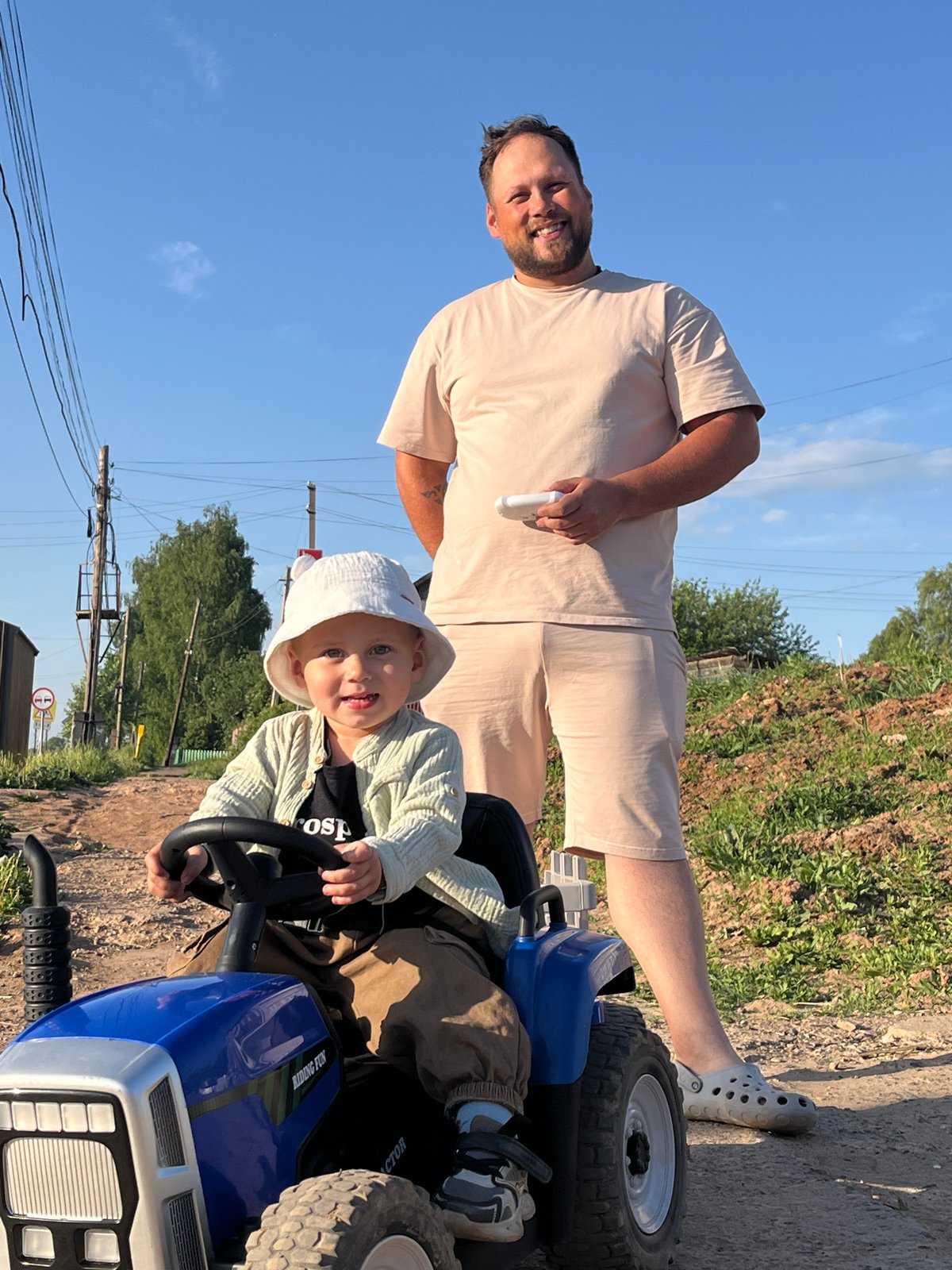 Family enjoys toy tractor playtime in rural Russia
