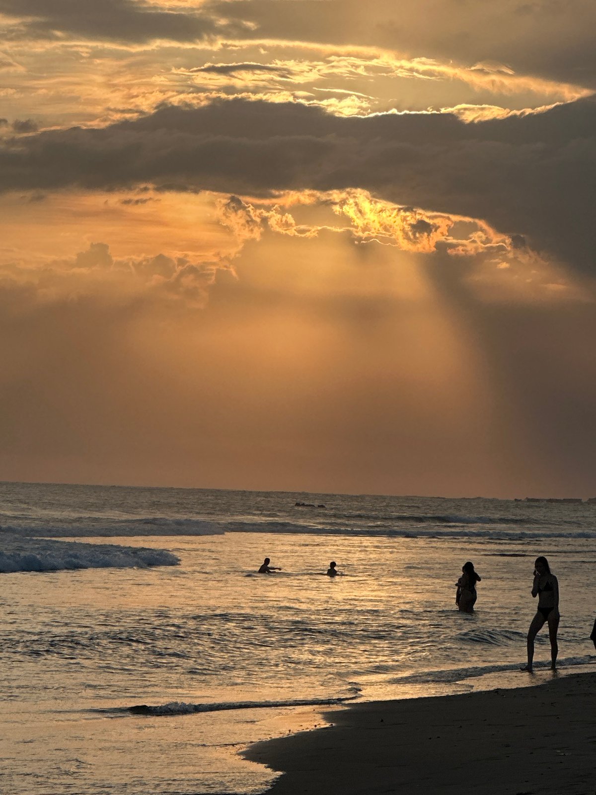Sunset across Bali's west-facing beaches, crowds and color
