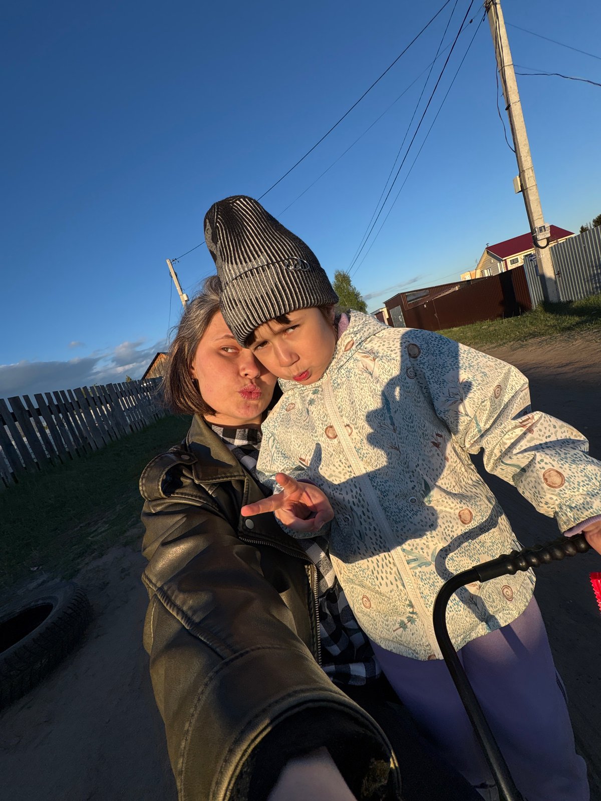 Family plays soccer, takes photos in Chaikovsky yard