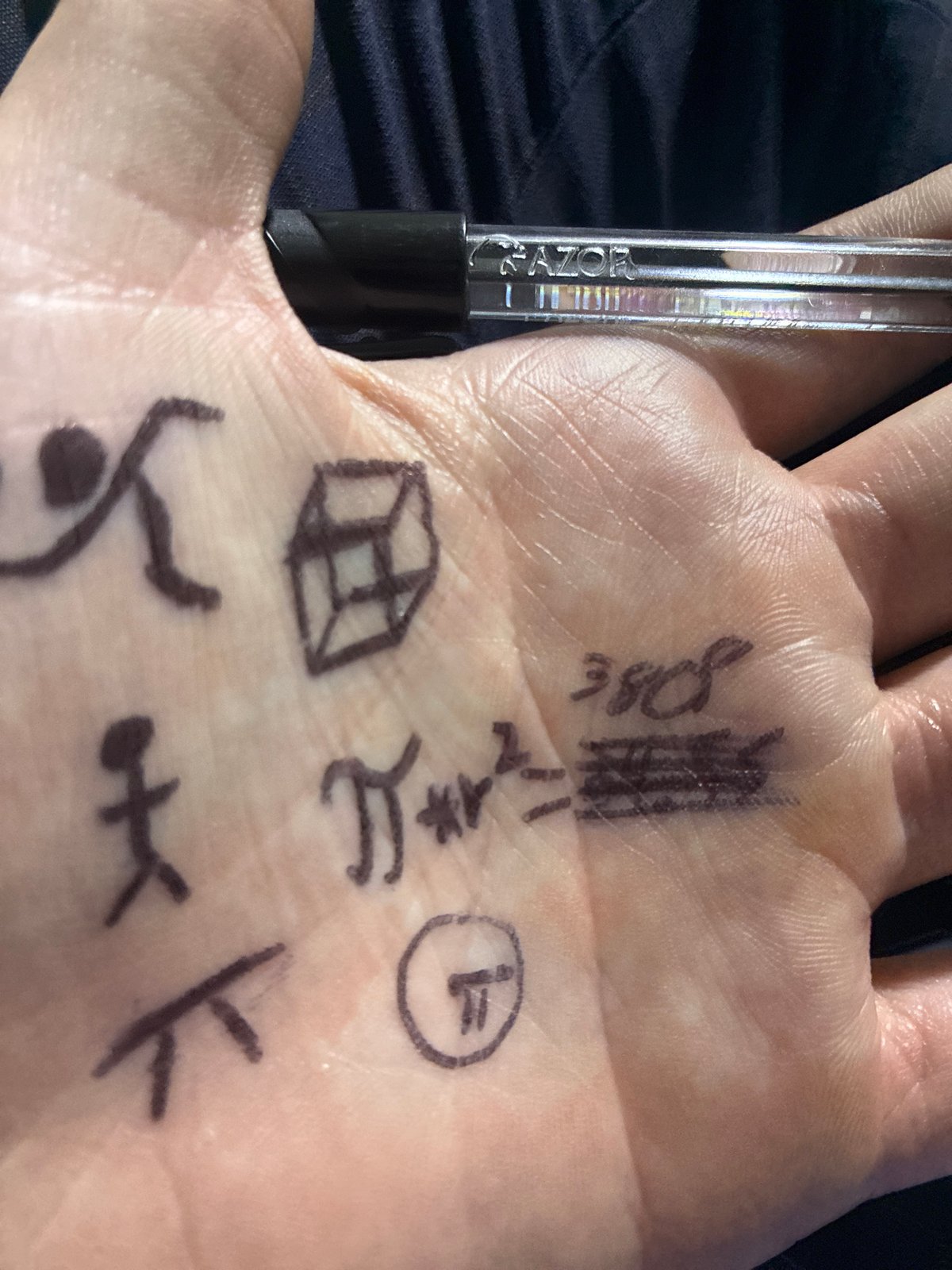 Person draws on palm during warehouse meeting in Mexico