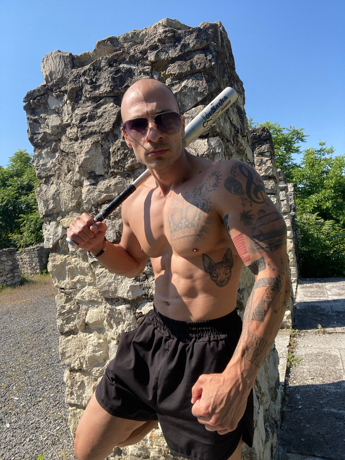 Tattooed man performs athletic stunts at Bulgarian ruins