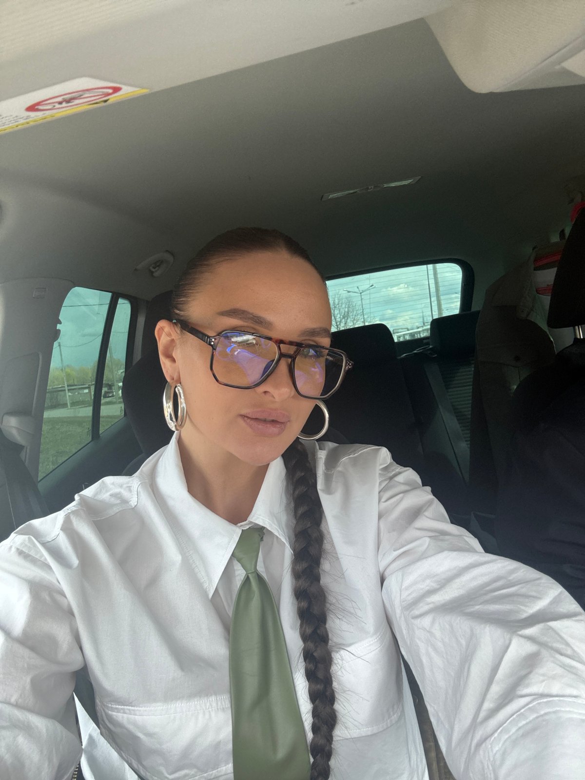 Woman takes car selfie in white shirt, Chaikovsky