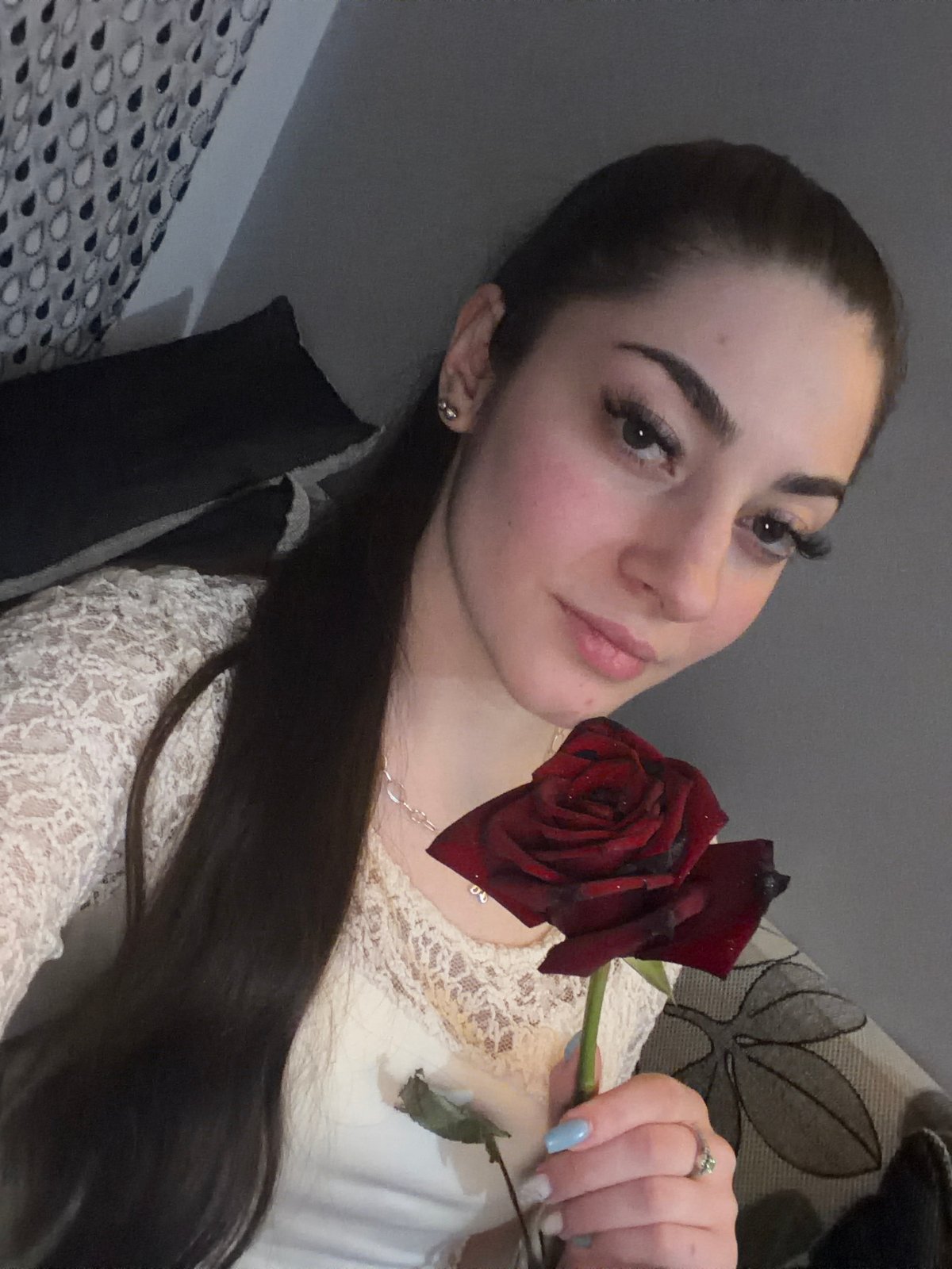 Woman holds red rose in Sofia evening scene