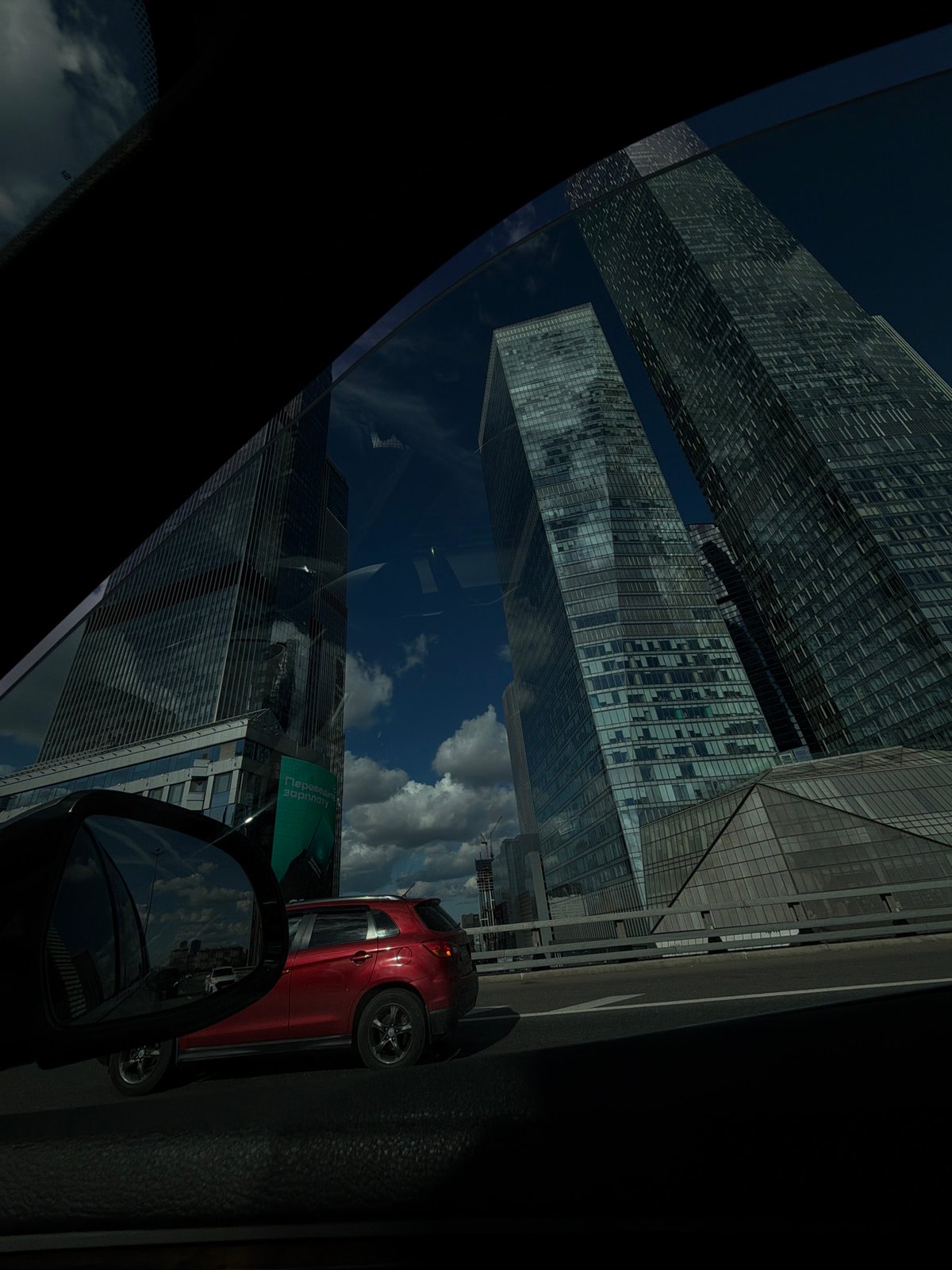 Rolling past Moscow-City's glass towers on a clear afternoon