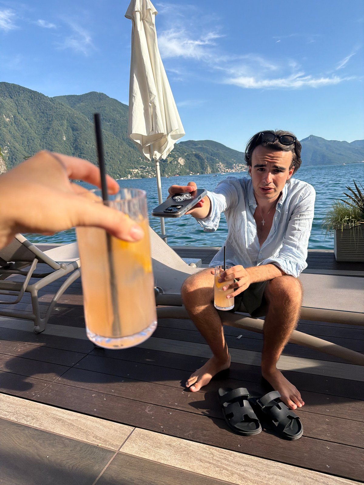 Chilling on a lakeside deck in Lugano, Alps in view