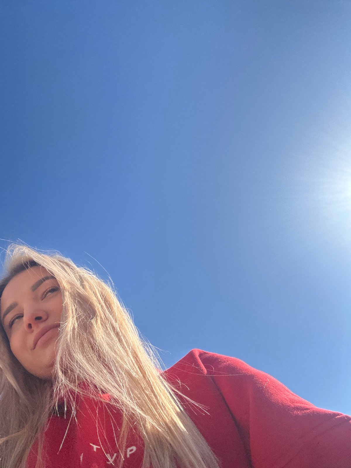 Woman in red sweatshirt walks through Budva streets