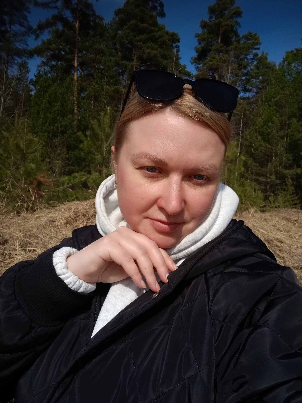 Woman takes selfies in spring forest near Dubovaya, Russia