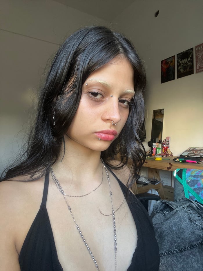 Pierced individual photographed multiple times in Buenos Aires mirror selfies