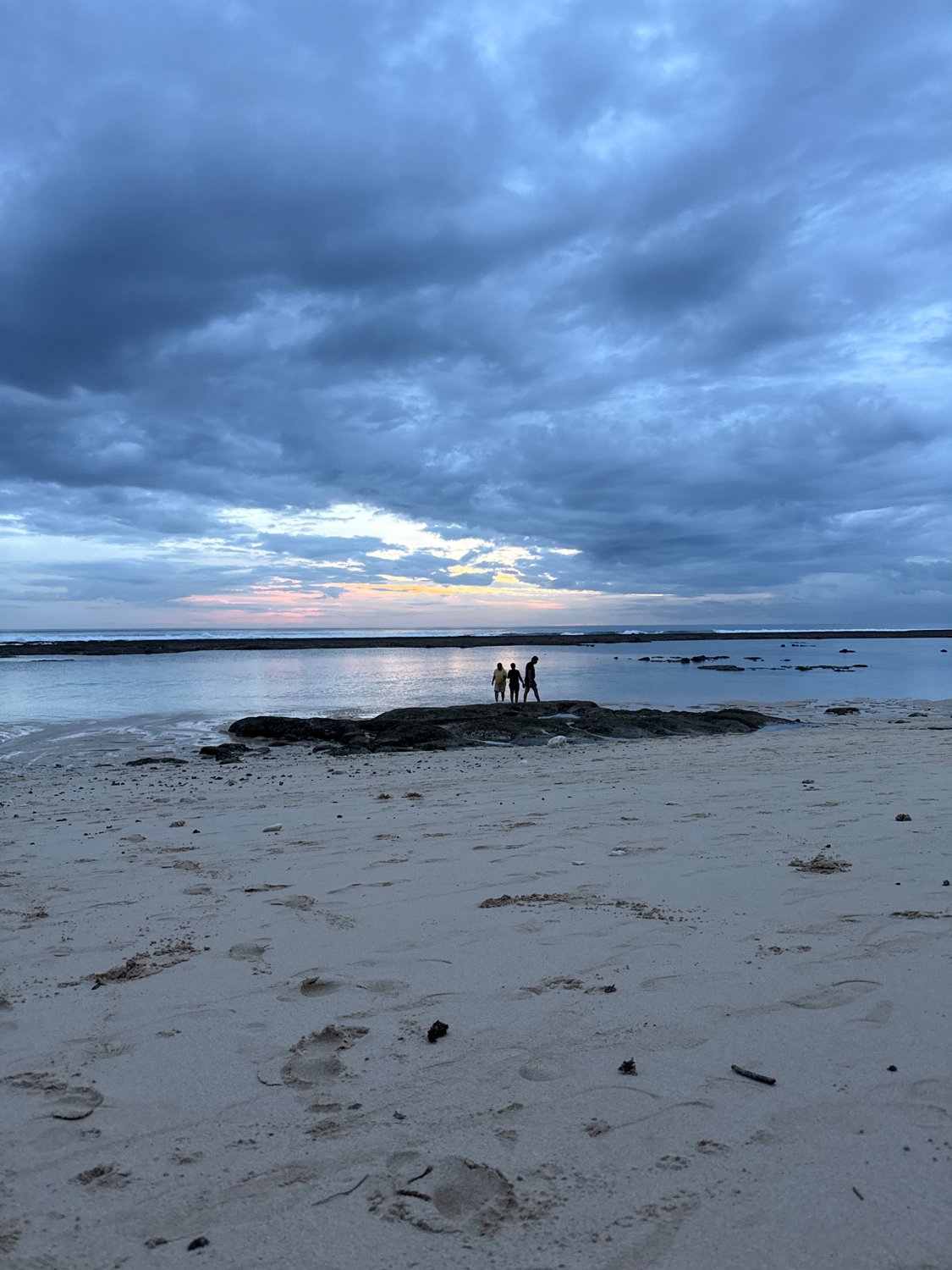 Beach visitor enjoys quiet morning under dramatic skies
