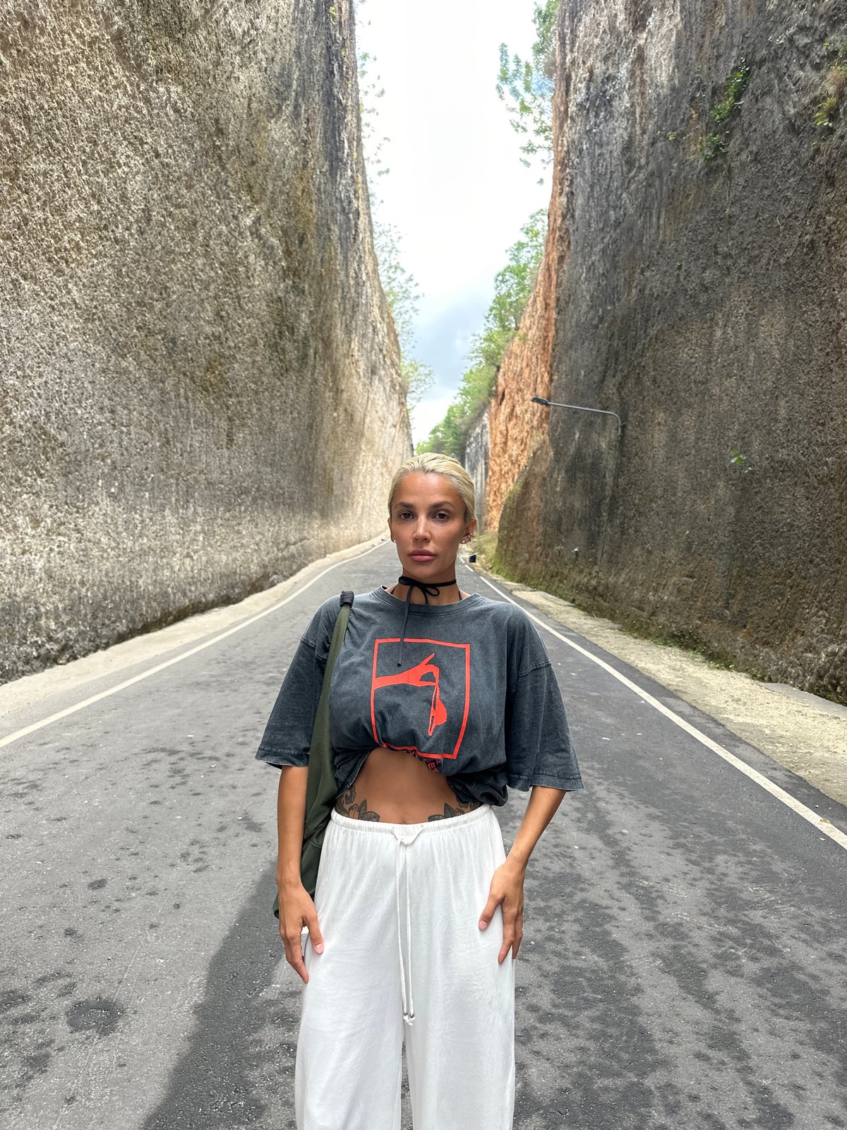 Woman photographed on rock-walled road in Kuta Selatan