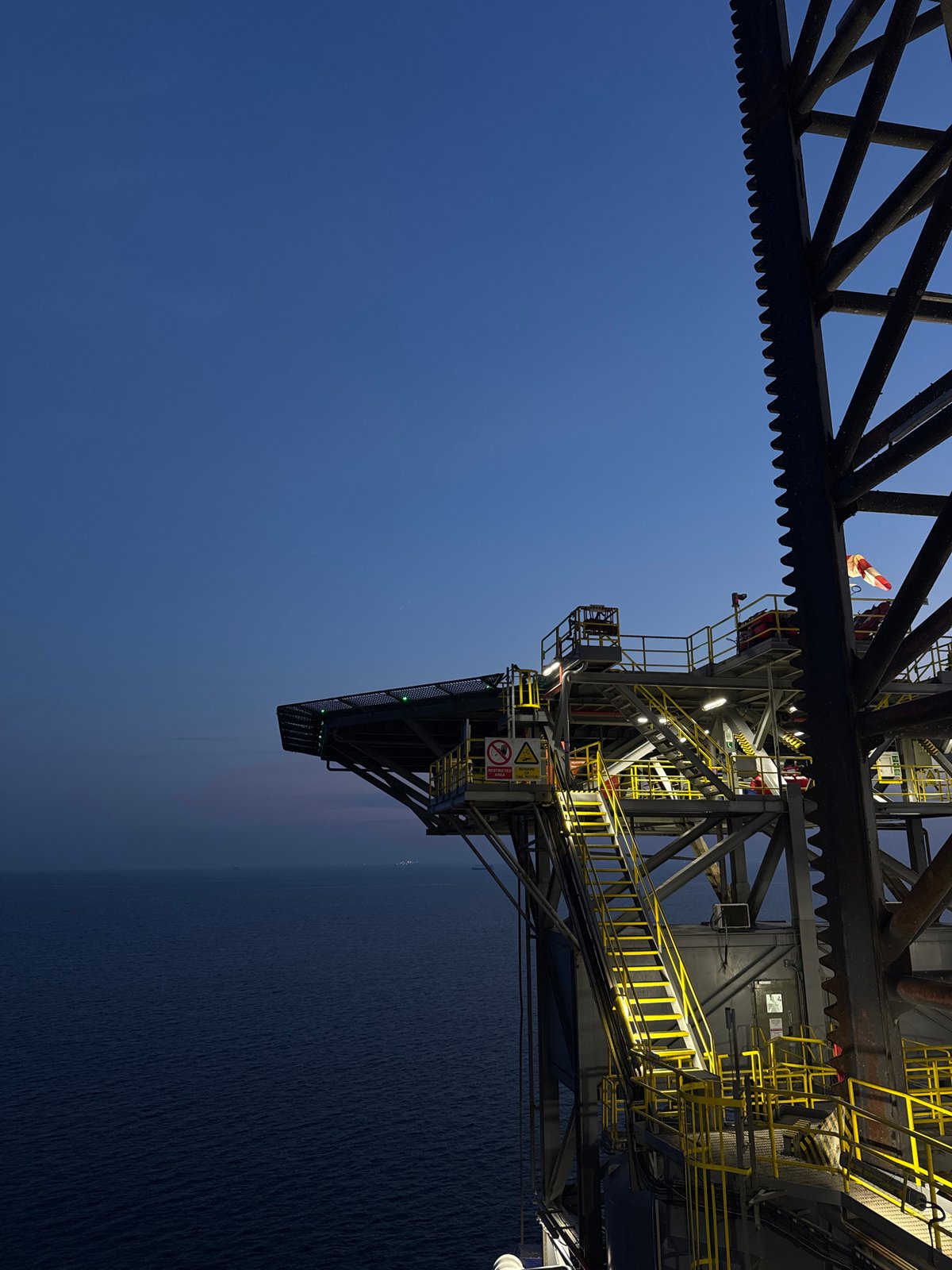 Offshore oil rig at sea, day and golden hour views