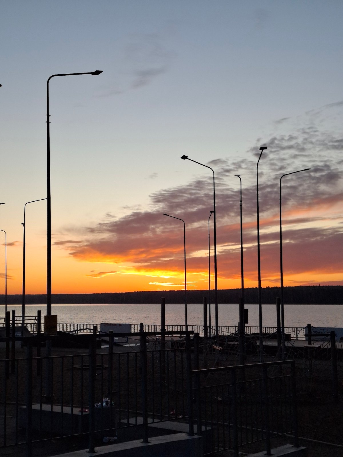 Sunset captured along Chaikovsky waterfront with decorated mermaid statue