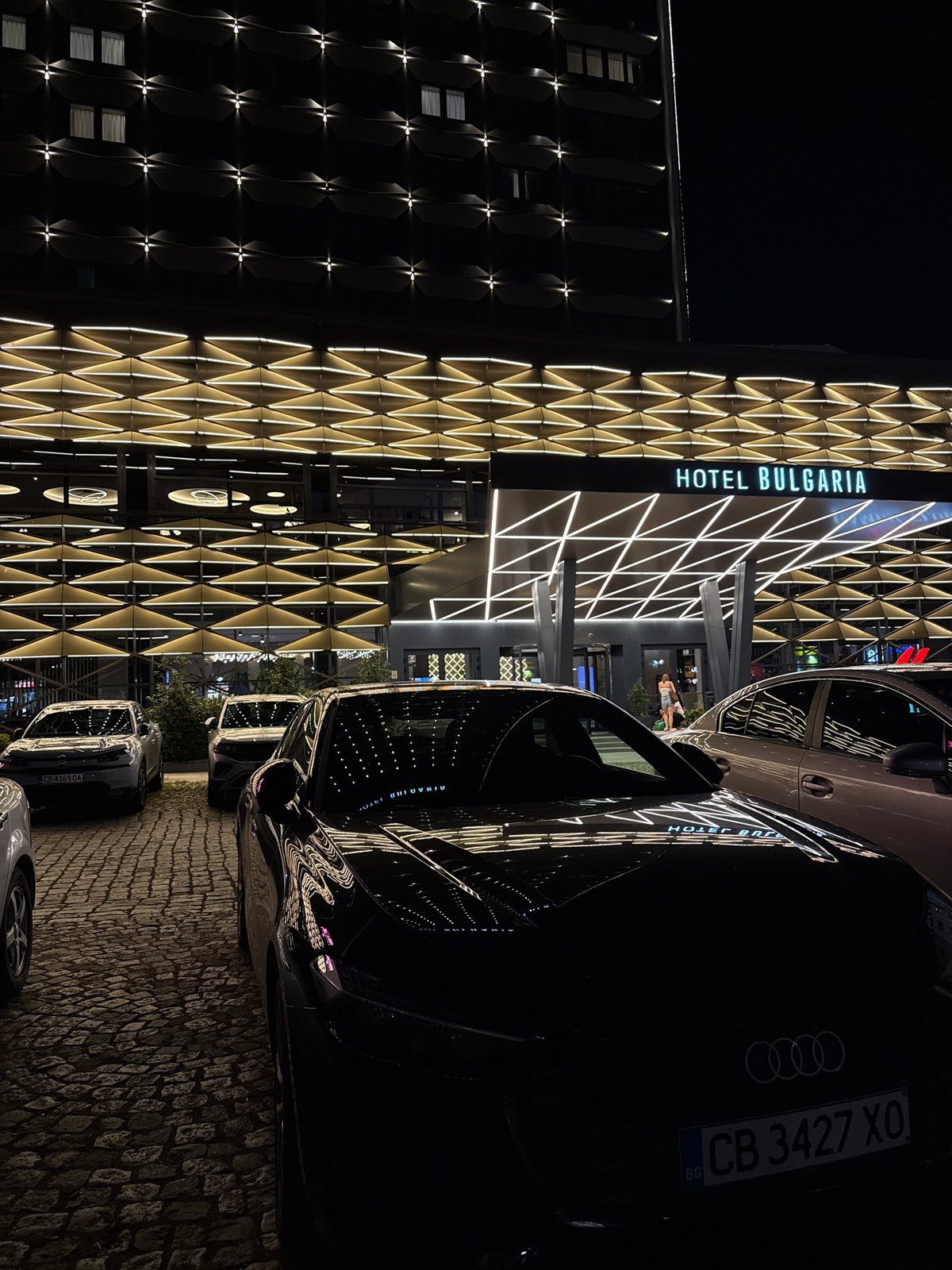 Evening at Hotel Bulgaria: lit facade, cozy lounge, statement jewelry