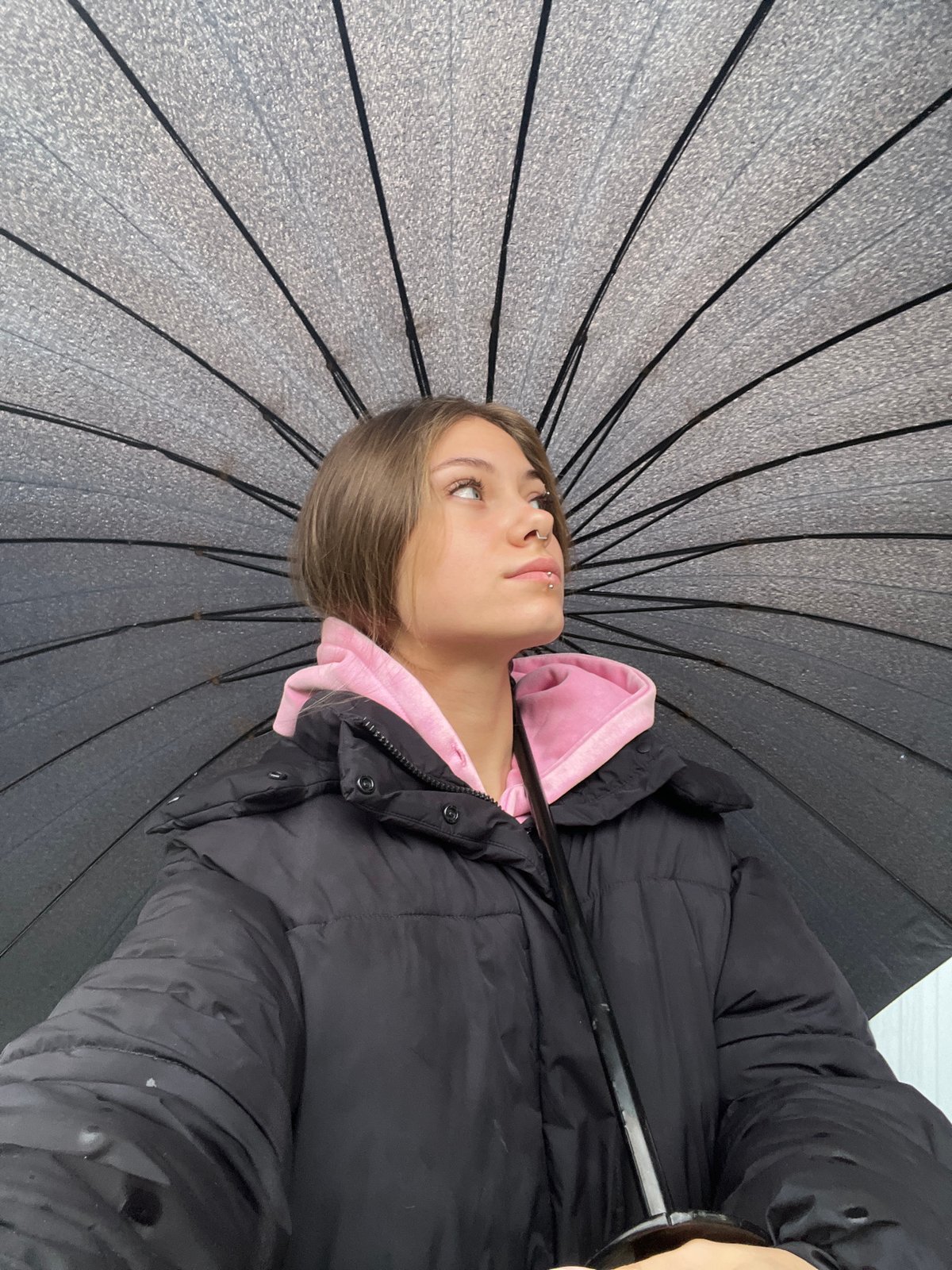 Woman with umbrella spotted in Russian town during early morning