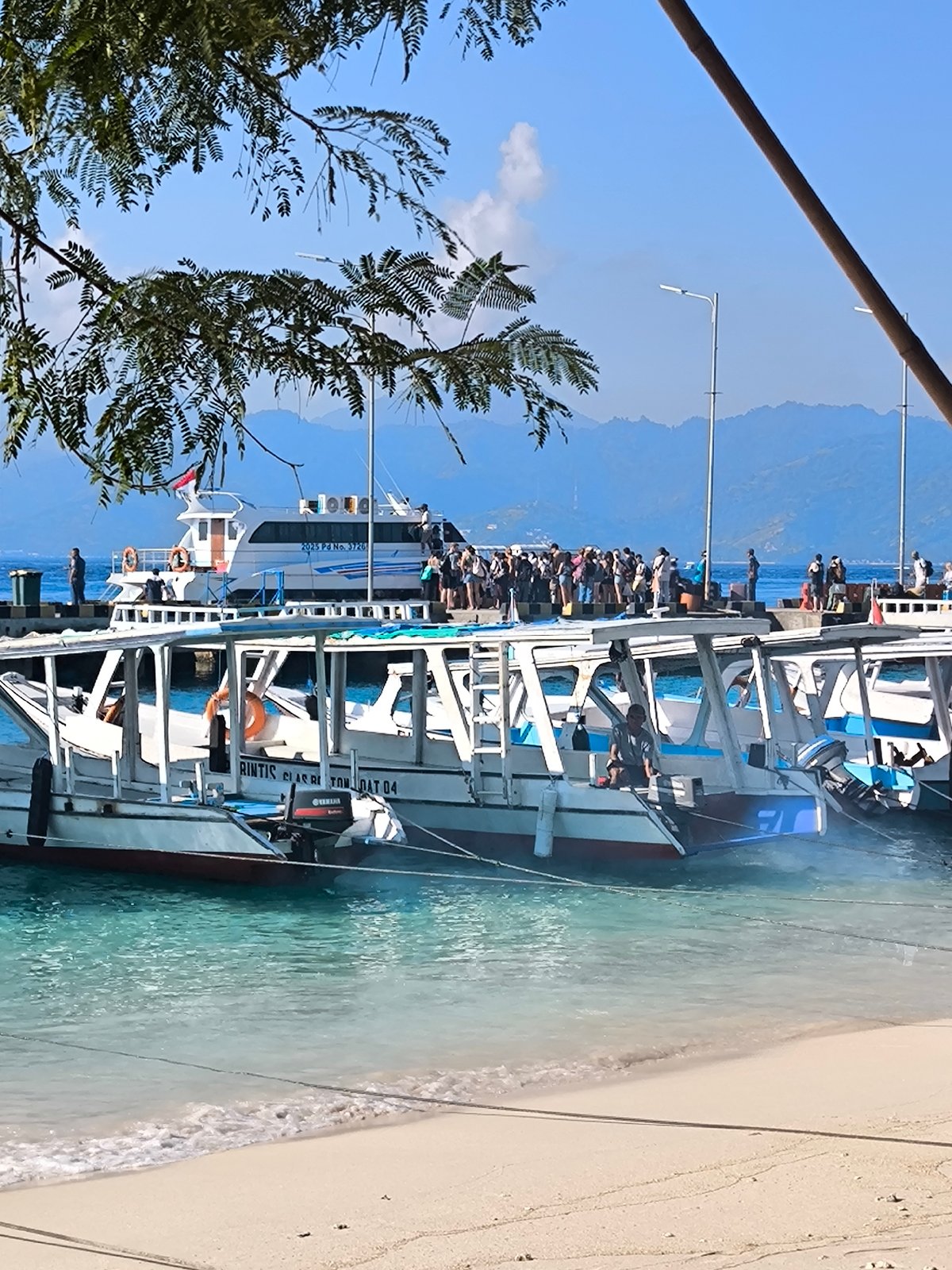 Boats moored at a quiet tropical harbor in Indonesia
