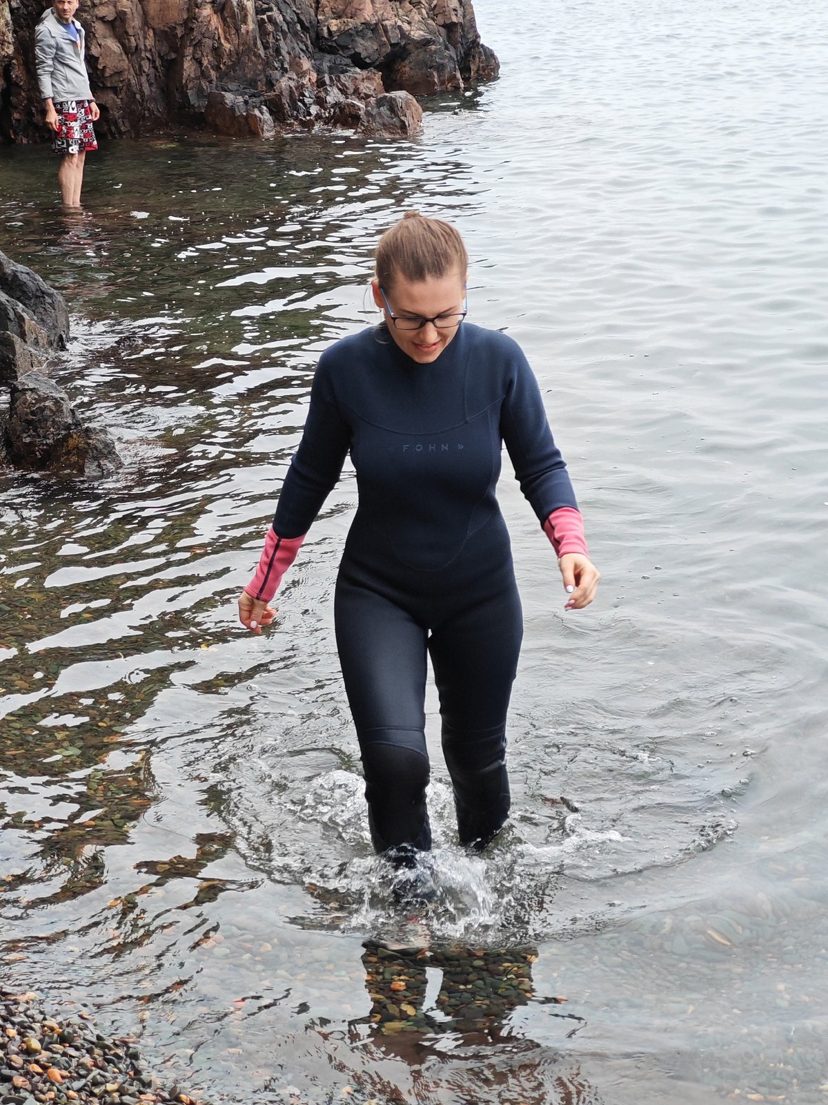 Suiting up for a cold-water swim on a rocky Russian shore