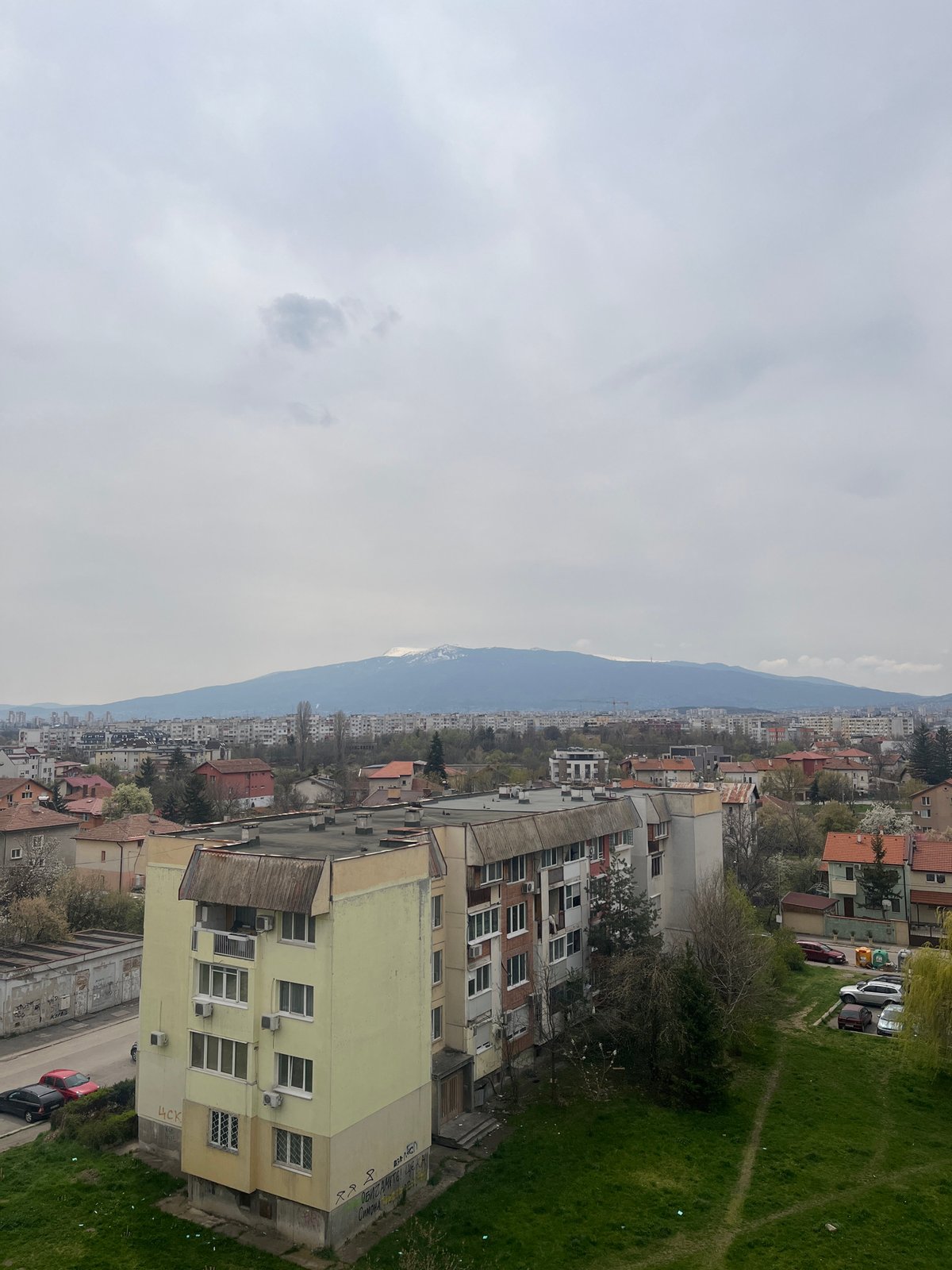 Overcast morning captured across Sofia's residential districts, mountains visible